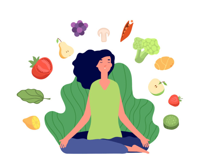 Mulher praticando mindful eating com frutas e vegetais ao redor, representando alimentação consciente e saudável.