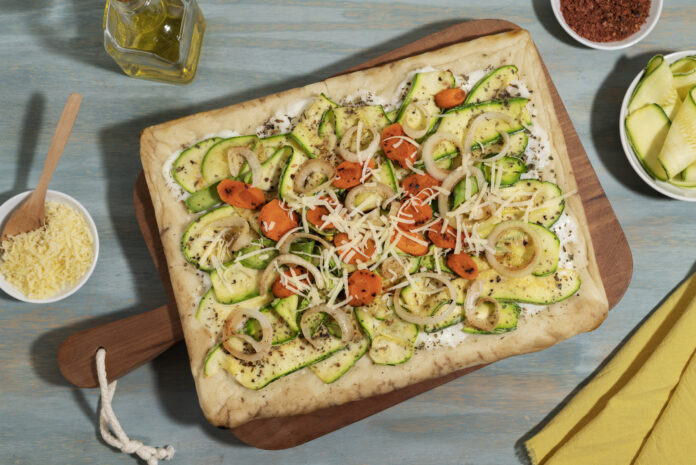 Pizza saudável de vegetais frescos com cenoura, abobrinha e cebola